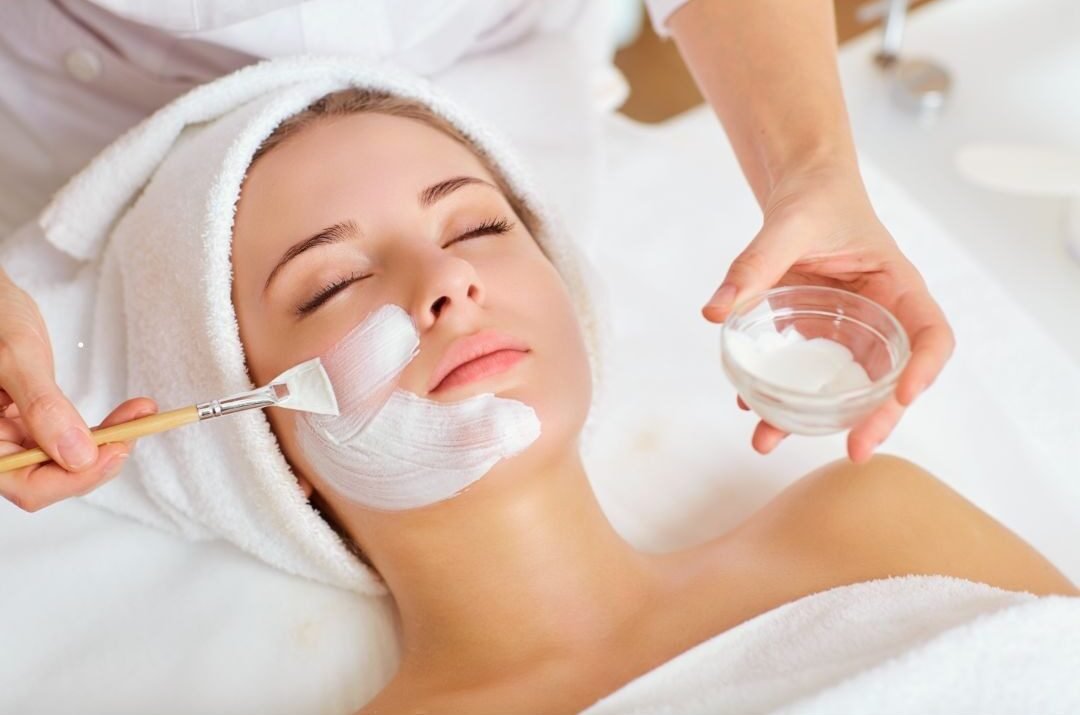 Young woman receiving a professional facial beauty treatment in Alanya
